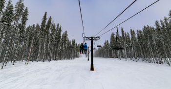 Lookout-Pass Skiers on a chairlift at Lookout Pass Ski & Recreation Area, a popular North Idaho ski mountain known for deep snow and easy access off I-90.